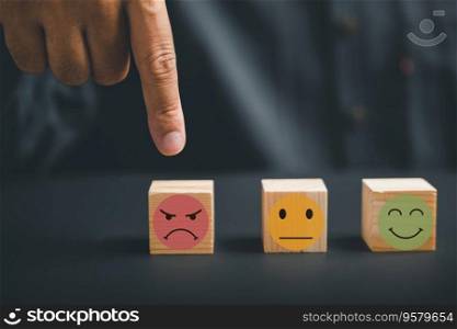 Unhappy customer expressing dissatisfaction with sad emoticon on wooden block. Concept of customer experience dissatisfaction, bad review and low rating. unsatisfied customers on business reputation.