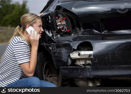 Unhappy Female Driver With Damaged Car After Accident Calling Insurance Company On Mobile Phone