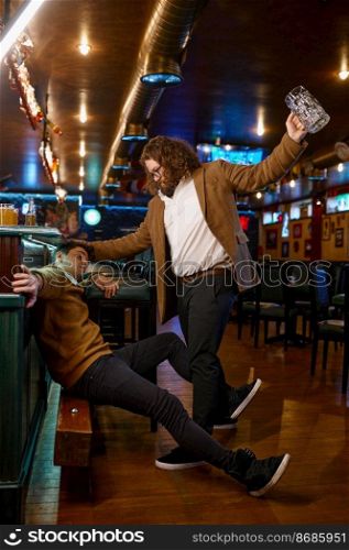 Unhappy furious friends fighting at pub. Soccer football fans misunderstanding. Fury guy trying to hit mate with empty beer glass. Unhappy furious friends fighting at pub