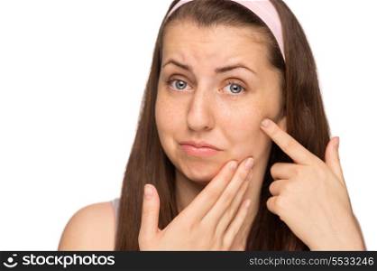 Unhappy girl squeezing pimple on cheek teenage beauty isolated