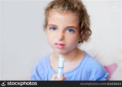 Unhappy kid girl with syringe medicine dose funny expression