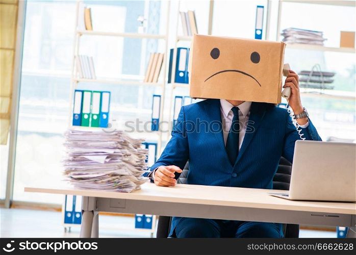 Unhappy man with box instead of his head 