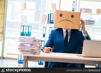 Unhappy man with box instead of his head 