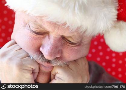 unhappy older man with hands against cheeks