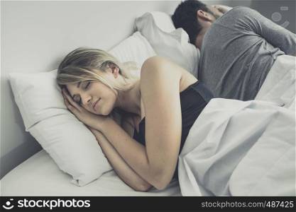 Unhappy or upset couple sleeping in bed, ignoring each other avoiding sex, having conflict or sexual problems concept