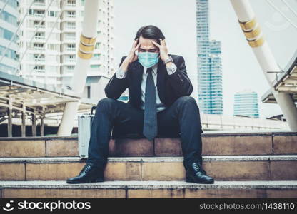 Unhappy sad business man with face mask protect from Coronavirus or Covid-19. Concept of unemployment problem caused by Coronavirus Covid-19.