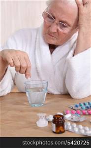 Unhappy senior citizen taking her medication