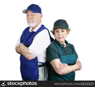 Unhappy senior couple forced to work menial service jobs because of poor retirement planning. Isolated on white.