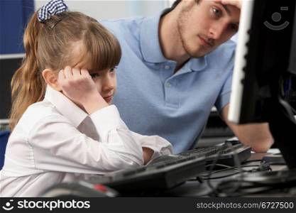 Unhappy teacher and girl using computer in class