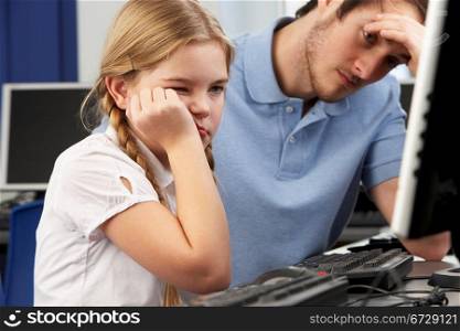 Unhappy teacher and girl using computer in class