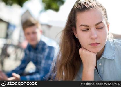 Unhappy Teenage Couple Having Argument In Urban Setting