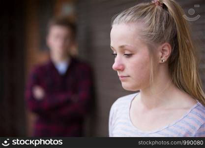 Unhappy Teenage Couple In Urban Setting