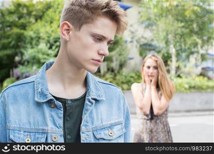 Unhappy Teenage Couple With Relationship Problem In Urban Setting