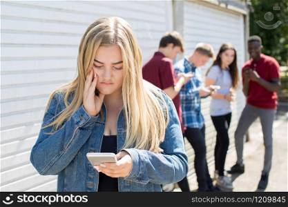 Unhappy Teenage Girl Being Bullied By Text Message