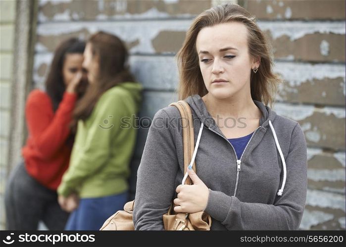 Unhappy Teenage Girl Being Gossiped About By Peers