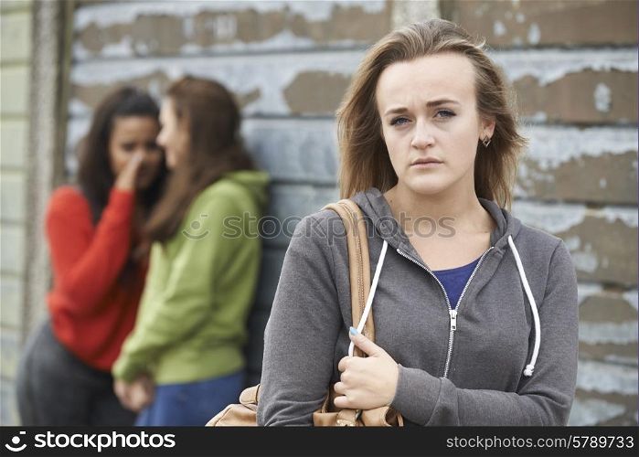 Unhappy Teenage Girl Being Gossiped About By Peers