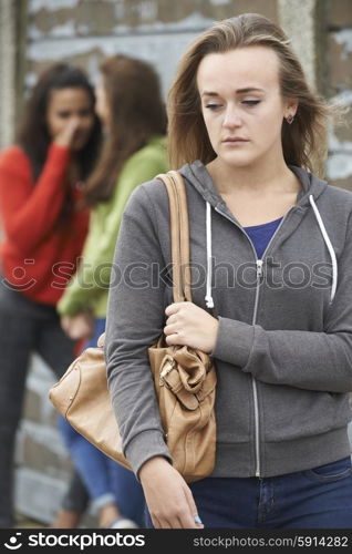 Unhappy Teenage Girl Being Gossiped About By Peers