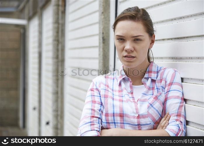 Unhappy Teenage Girl In Urban Setting