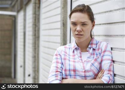 Unhappy Teenage Girl In Urban Setting