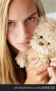 Unhappy teenage girl with cuddly toy