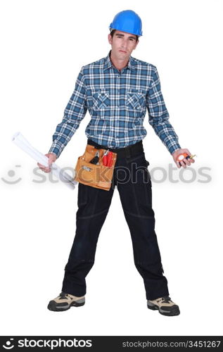 Unhappy tradesman holding his tools and rolled-up drawings