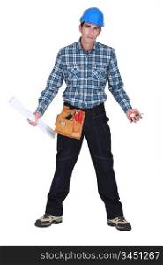 Unhappy tradesman holding his tools and rolled-up drawings