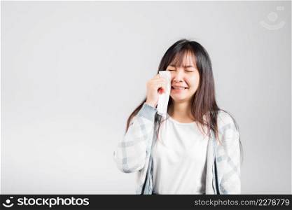 Unhappy woman bad mood her cry wipe mucus with tissue, beautiful young female stress feel sneezing sinus use towel to wipe tear from eyes, studio shot isolated on white background with copy space