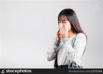Unhappy woman bad mood her cry wipe mucus with tissue, beautiful young female stress feel sneezing sinus use towel to wipe snot from nose, studio shot isolated on white background with copy space