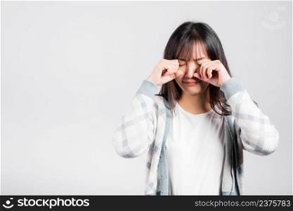 Unhappy woman bad mood her cry wipe tears with fingers, Asian beautiful young female stress feeling sad unhappy crying, studio shot isolated on white background with copy space