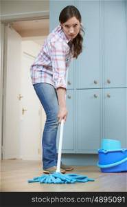 Unhappy Woman Cleaning Kitchen Floor With Mop
