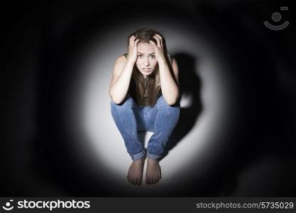 Unhappy Woman Sitting In Pool Of Light