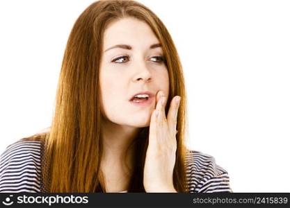 Unhappy woman touching her cheek feeling pain, tooth ache, dentistry problems concept. Isolated background.. Unhappy woman touching her cheek feeling pain