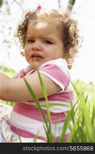 Unhappy Young Girl Sitting In Summer Field