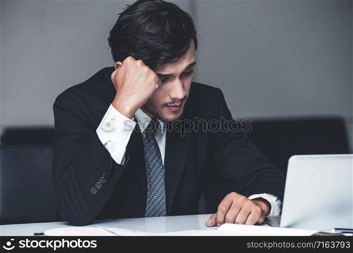 Unhappy young man, businessman feels stress at the office because of economic crisis and awful company loss. Business failure concept.