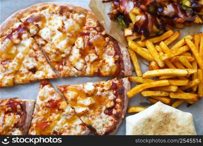 Unhealthy concept. Fast Food - Pizza, Fried Potato. Close up.. Unhealthy concept. Fast Food - Pizza, Fried Potato. Close up. Popular fast food recipes