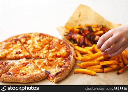 Unhealthy concept. Fast Food - Pizza, Fried Potato. Close up.. Unhealthy concept. Fast Food - Pizza, Fried Potato on a white background. Close up. Popular fast food recipes