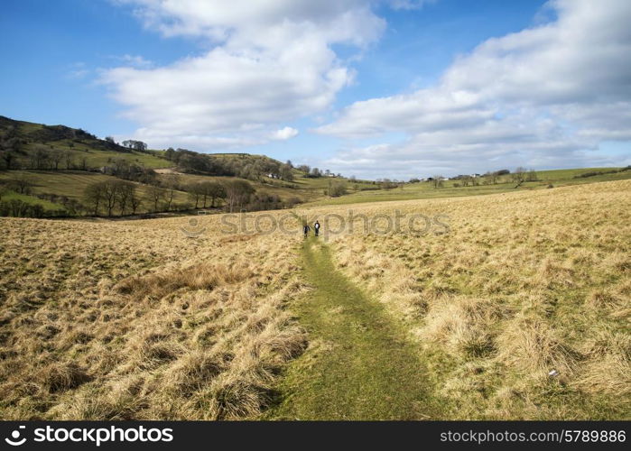 Unidentified hikers in landscape in Peak District in UK