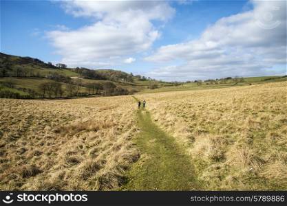 Unidentified hikers in landscape in Peak District in UK