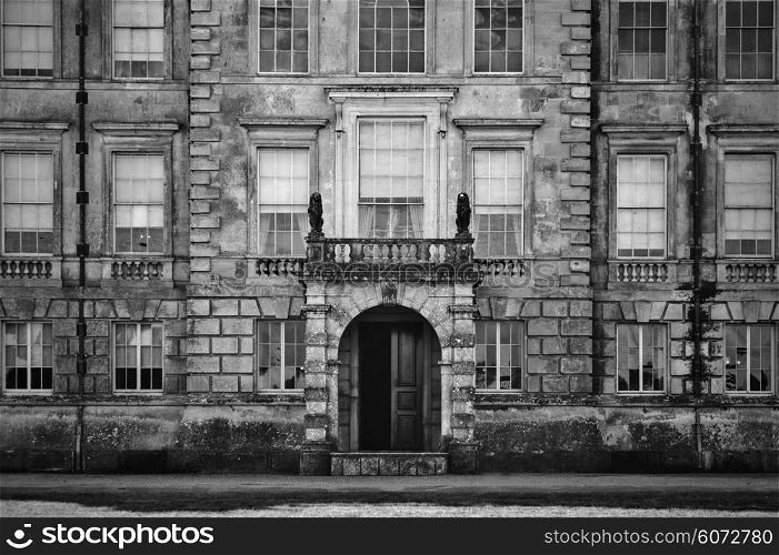 Unidentified old English mansion house with balcony overlooking entrance