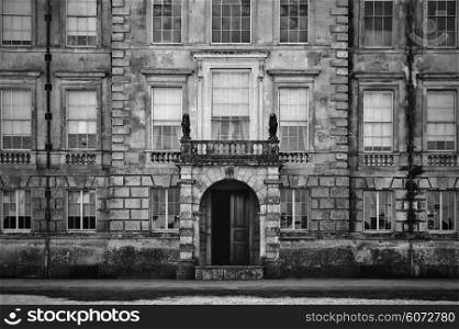 Unidentified old English mansion house with balcony overlooking entrance