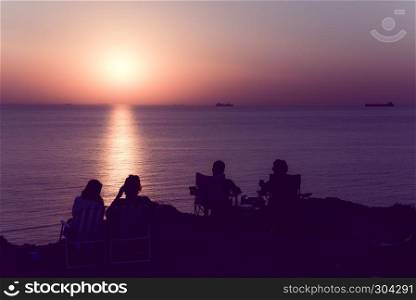 Unidentified people wait for sunset at Bozcaada,Turkey