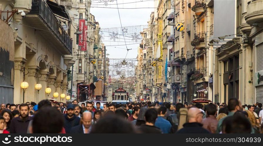 Unidentified people walk and explore at Istiklal street,a popular street at Beyoglu district in Istanbul,Turkey.06 October 2014. Unidentified people walk and explore at Istiklal street