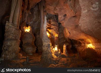 Unique cave formation- big stalactites, stalagmites and columns. Shooting deep under ground with candle light