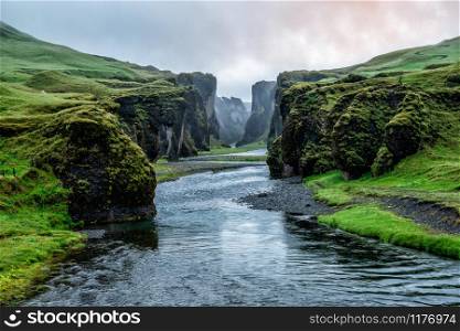 Unique landscape of Fjadrargljufur in Iceland. Top tourism destination. Fjadrargljufur Canyon is a massive canyon about 100 meters deep and about 2 kilometers long, located in South East of Iceland.