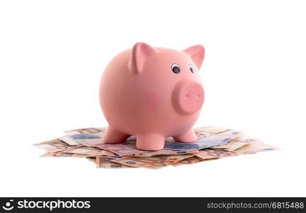 Unique pink ceramic piggy bank on top of money