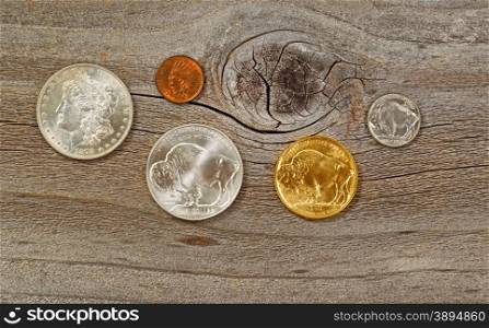 United States Mint issued American vintage coins, consisting of silver, gold and nickel metals, on rustic wood.
