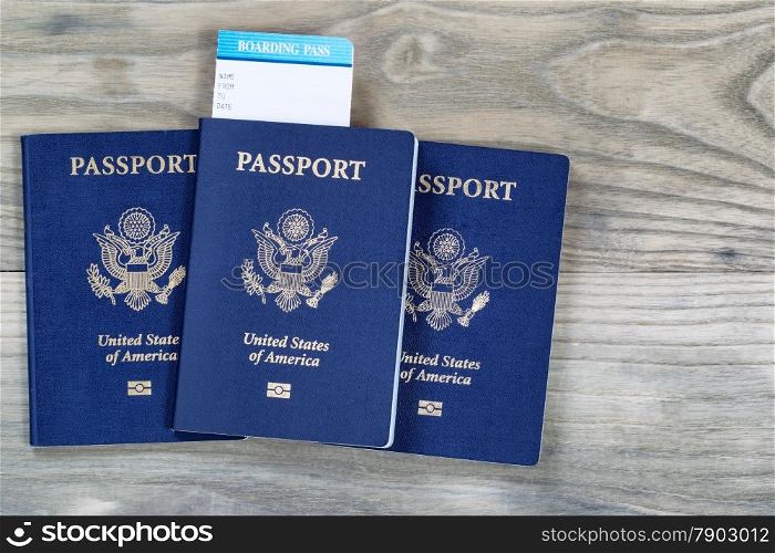 United States passports, boarding pass on faded wooden boards.