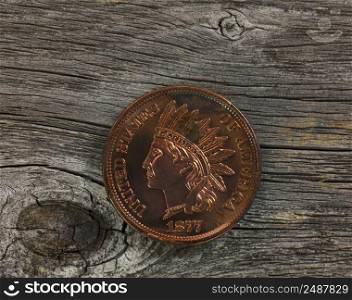 United States vintage historical Indian head one cent coin on rustic wood in close up view 