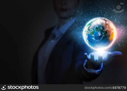 Universe. Businessperson holding planet Earth in palm. Elements of this image are furnished by NASA