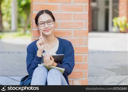 University Asian teen girl sitting happy smile in school c&us. student with tablet computer.